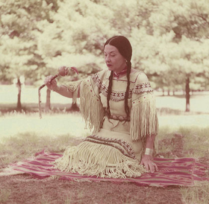 Te Ata holding a ceremonial rattle